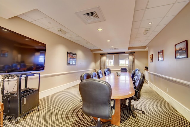 interior space with a paneled ceiling and carpet flooring