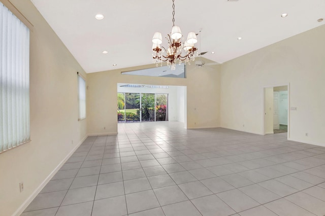 tiled empty room featuring an inviting chandelier and high vaulted ceiling