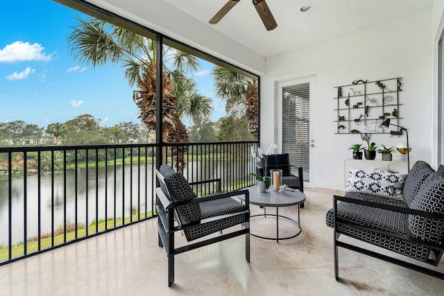 sunroom / solarium with a water view and a ceiling fan