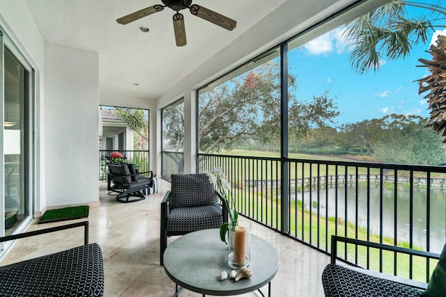 sunroom featuring a water view and plenty of natural light