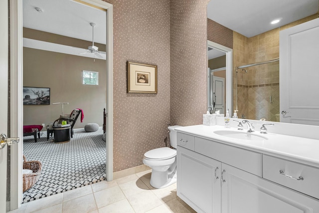 bathroom featuring tile patterned floors, ceiling fan, tiled shower, toilet, and vanity