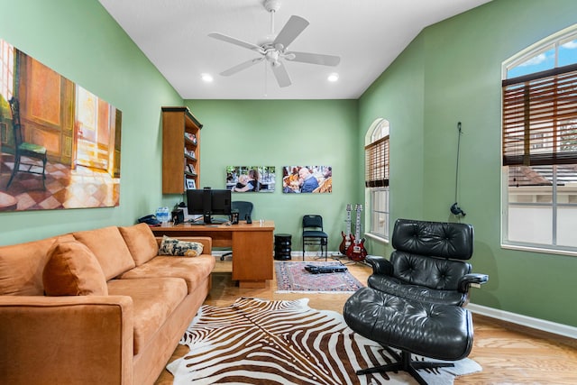 office with ceiling fan, vaulted ceiling, light hardwood / wood-style flooring, and a healthy amount of sunlight