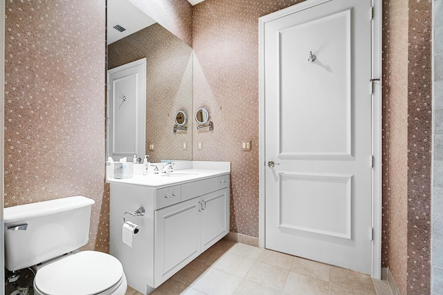 bathroom featuring visible vents, wallpapered walls, toilet, vanity, and tile patterned floors