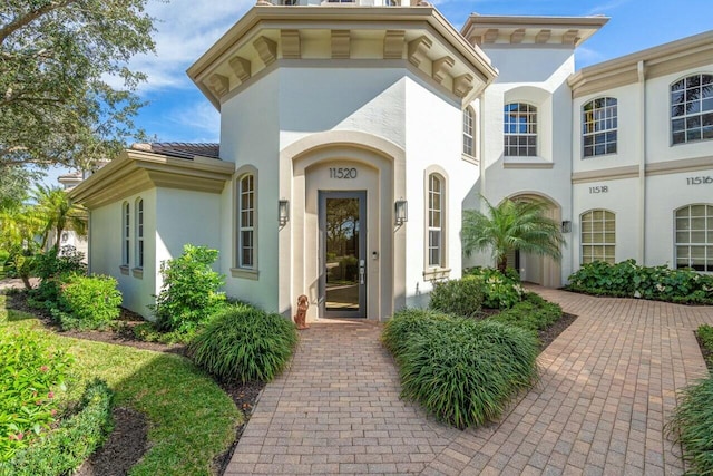 doorway to property with stucco siding