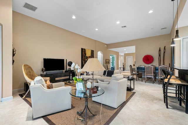 living area featuring visible vents and recessed lighting