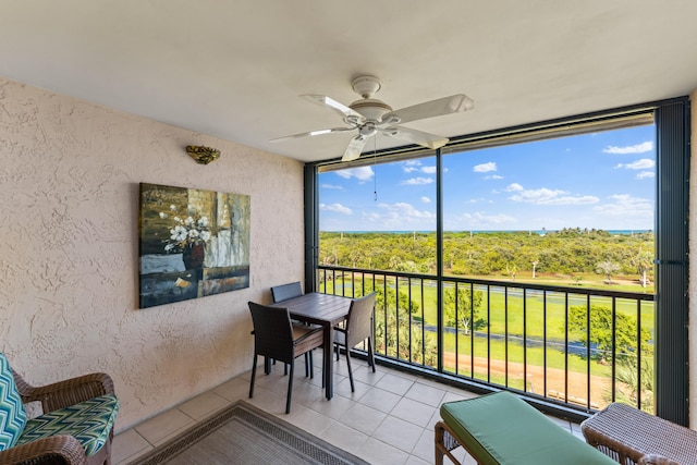 sunroom featuring ceiling fan