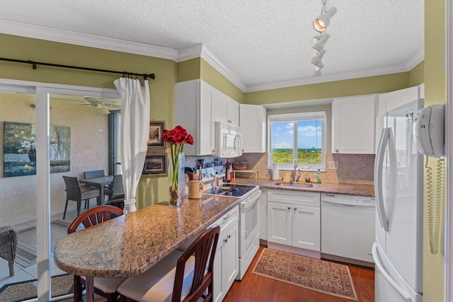 kitchen featuring white cabinetry, white appliances, and light stone counters