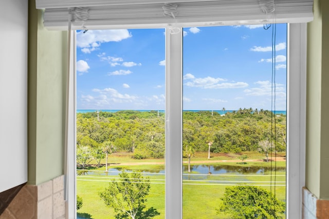 doorway to outside with a water view