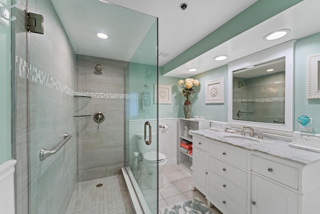 bathroom with vanity, toilet, and a shower with shower door