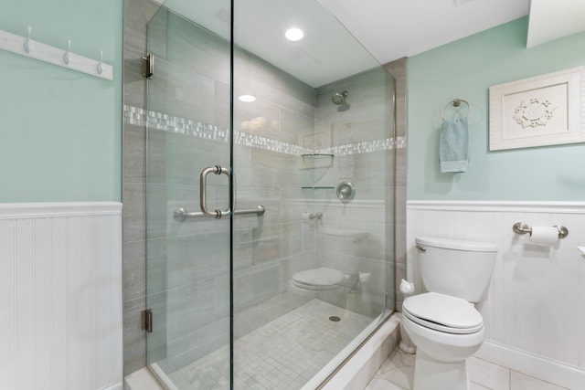 bathroom featuring toilet and an enclosed shower