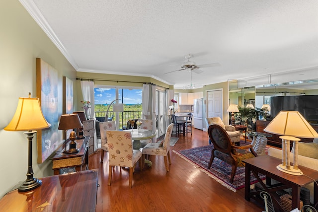 dining room featuring a textured ceiling, crown molding, ceiling fan, and wood-type flooring