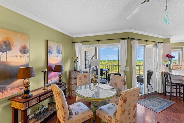 dining space featuring a textured ceiling, crown molding, and dark hardwood / wood-style floors