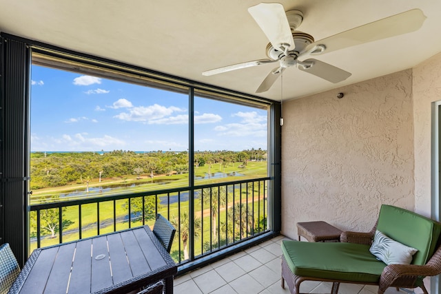 sunroom featuring ceiling fan