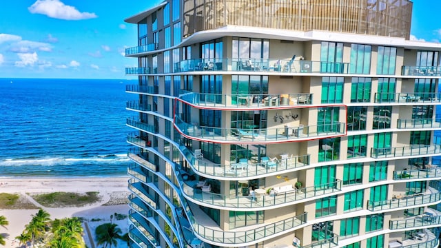 view of building exterior with a view of the beach and a water view