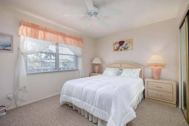 carpeted bedroom with ceiling fan and a closet