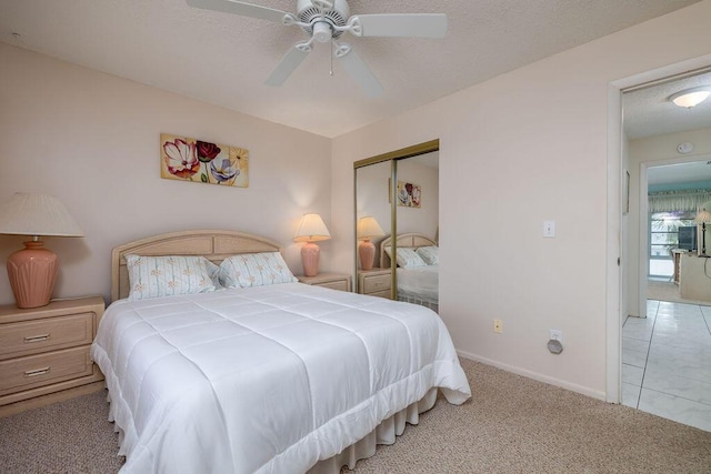 carpeted bedroom featuring ceiling fan and a closet