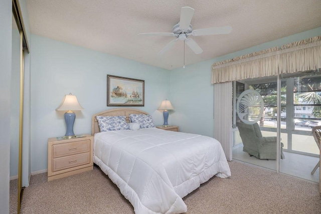 carpeted bedroom with a textured ceiling, access to outside, a closet, and ceiling fan