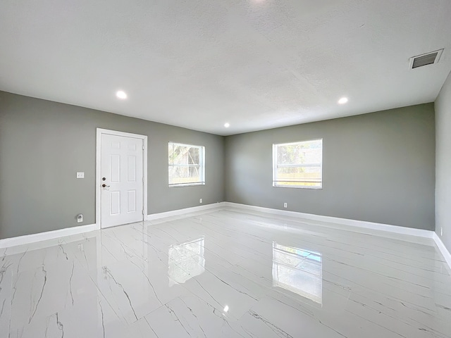 empty room featuring a textured ceiling