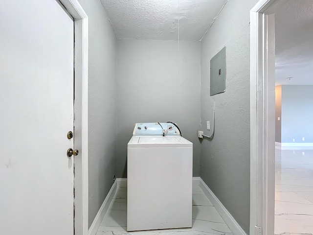 laundry area featuring a textured ceiling, electric panel, and washer / dryer