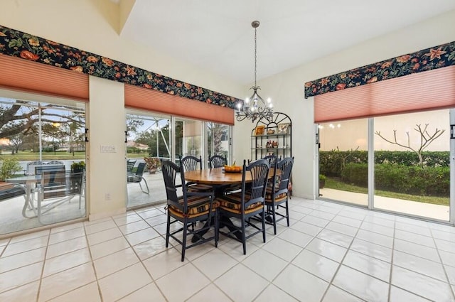 dining space featuring light tile patterned floors and an inviting chandelier