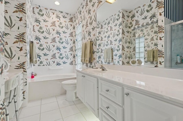 bathroom with tile patterned flooring, vanity, a bathtub, and toilet