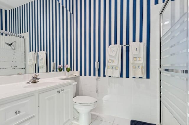 bathroom featuring tile patterned flooring, vanity, and toilet