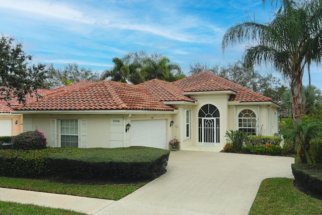 mediterranean / spanish home featuring a garage