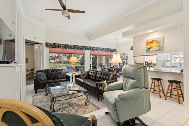 tiled living room with ceiling fan, crown molding, and a healthy amount of sunlight