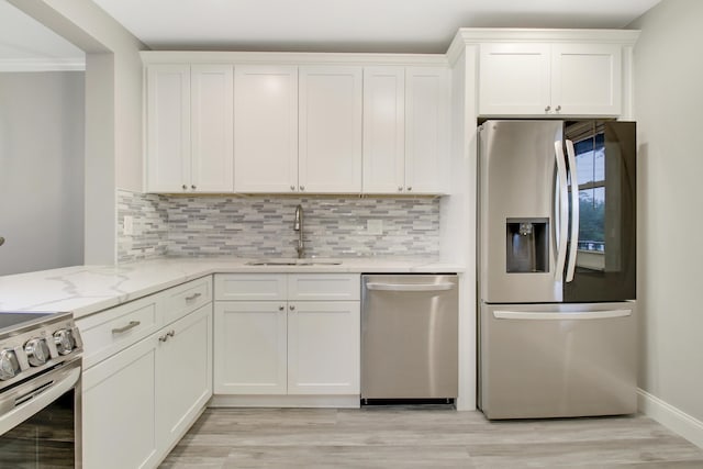 kitchen with stainless steel appliances, white cabinetry, and sink