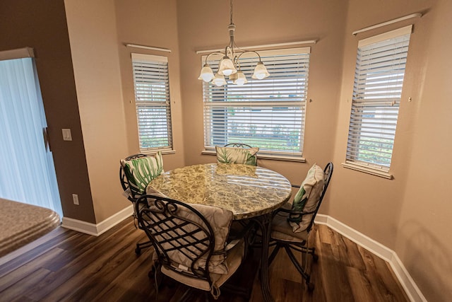 dining area featuring dark hardwood / wood-style flooring and a chandelier