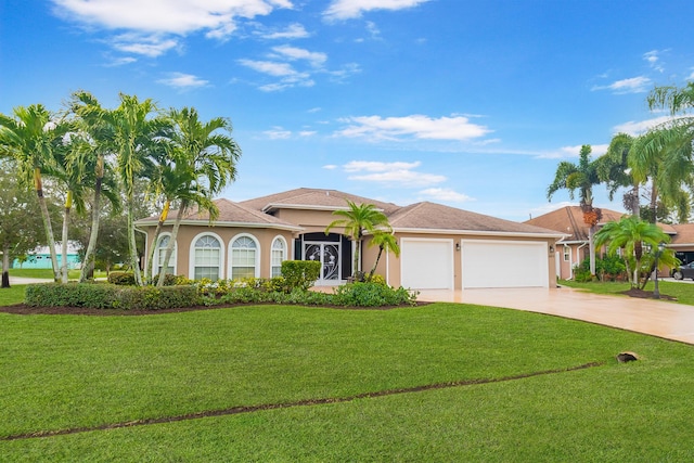 mediterranean / spanish house featuring a garage and a front yard