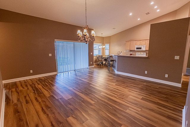 interior space featuring hardwood / wood-style flooring, high vaulted ceiling, and a notable chandelier