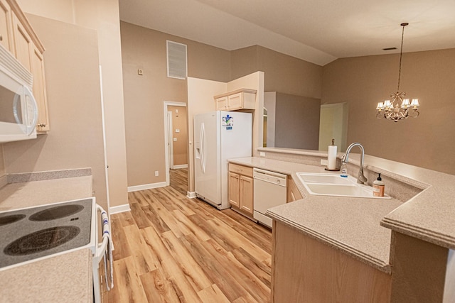 kitchen featuring sink, white appliances, hanging light fixtures, vaulted ceiling, and light brown cabinets