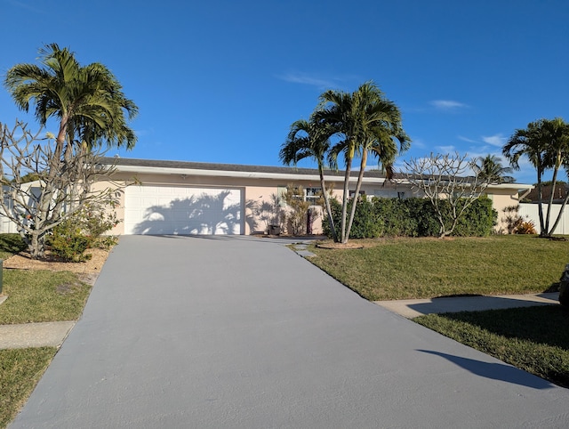 view of front of property with a garage and a front yard