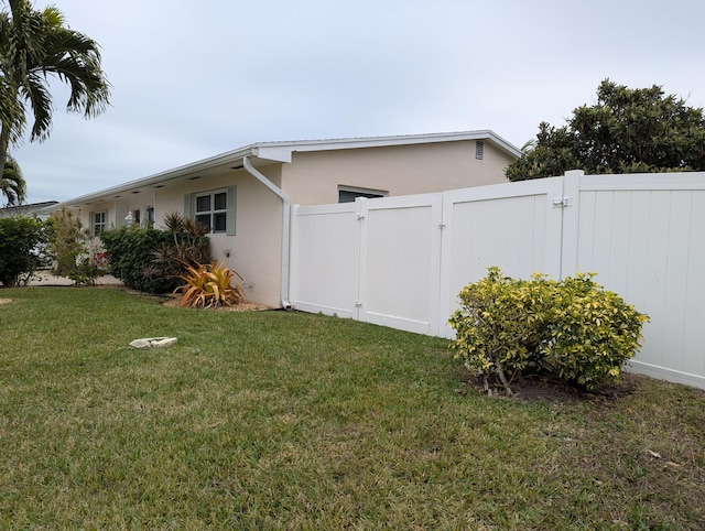 view of side of home with a lawn