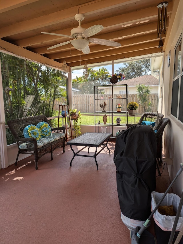 sunroom / solarium featuring a healthy amount of sunlight and ceiling fan