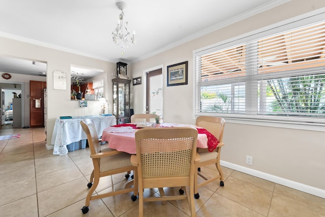 tiled dining room with a notable chandelier and crown molding