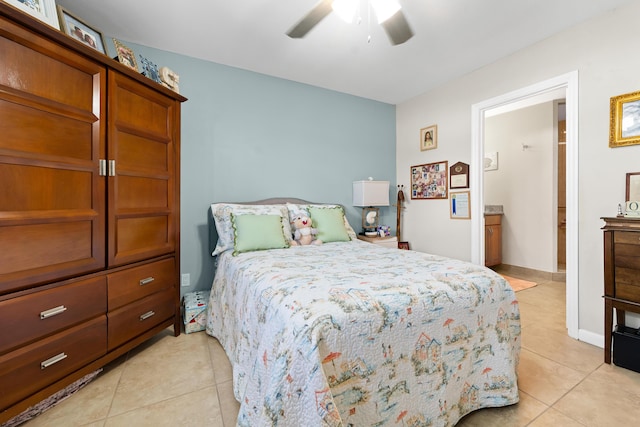 bedroom with ceiling fan, connected bathroom, and light tile patterned floors