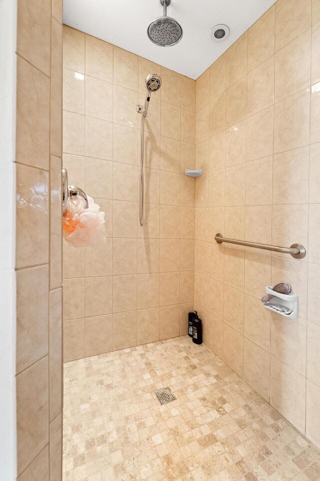 bathroom with a tile shower