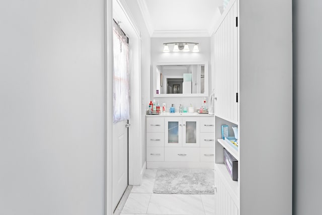 bathroom with crown molding and vanity