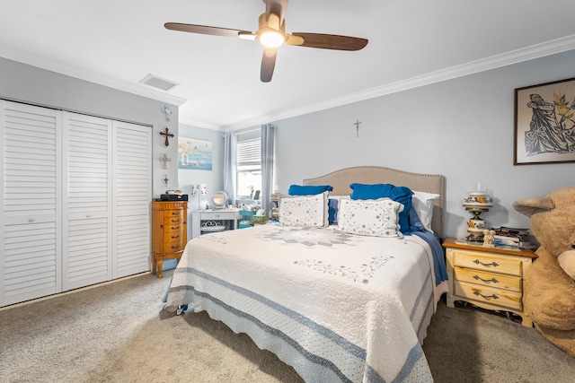 carpeted bedroom with crown molding, ceiling fan, and a closet