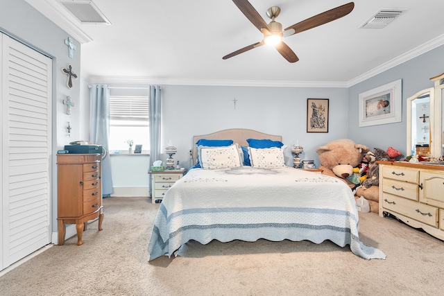 carpeted bedroom featuring crown molding and ceiling fan