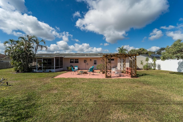 rear view of house featuring a pergola, a yard, a sunroom, and a patio