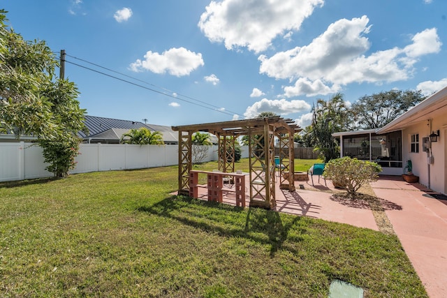 view of yard featuring a pergola, a patio area, and a sunroom