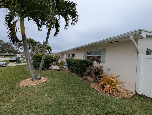 view of property exterior featuring a lawn