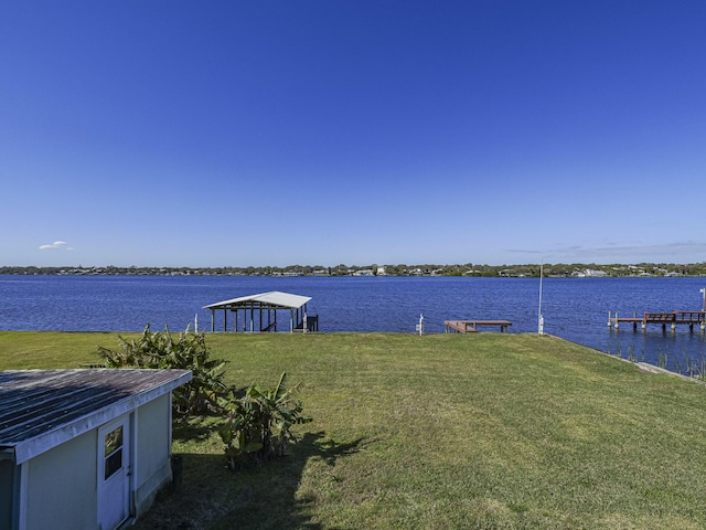 view of dock featuring a water view and a lawn