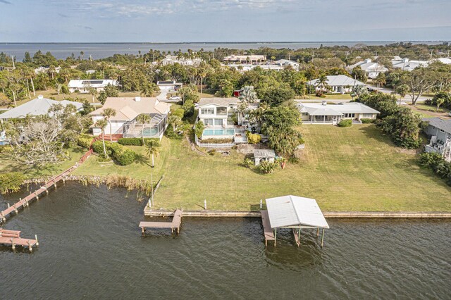 dock area with a water view and a yard