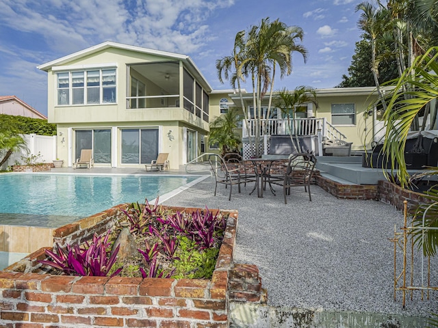 outdoor pool featuring outdoor dining area, a patio area, and fence