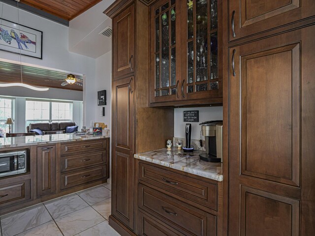 kitchen featuring pendant lighting, sink, light stone counters, stainless steel appliances, and wooden ceiling