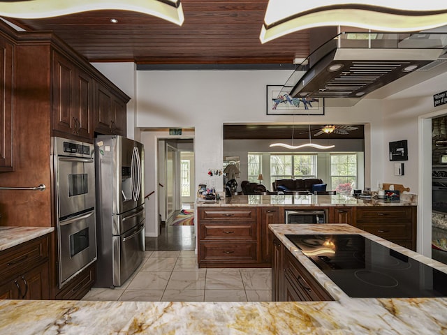 kitchen featuring light stone counters, range hood, marble finish floor, wine cooler, and appliances with stainless steel finishes